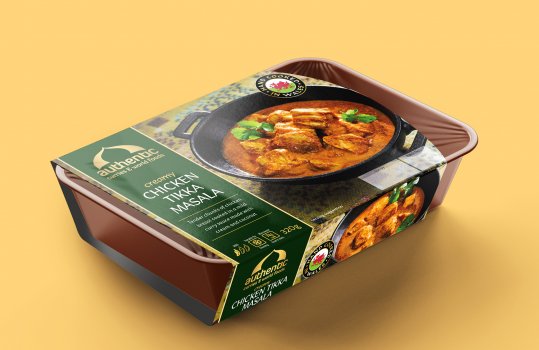 Digital render of a ready meal curry in a plastic tray with a cardboard sleeve featuring a food photograph of the curry inside the pack, plated up and placed on a patterned tablecloth